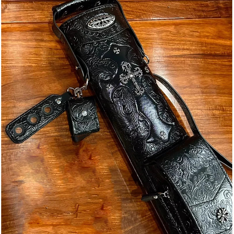 Black leather quiver with intricate designs on a wooden surface