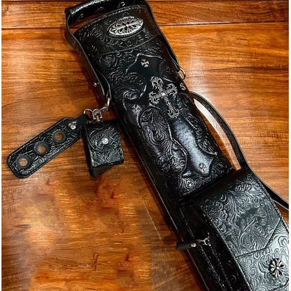 Black leather quiver with intricate designs on a wooden surface