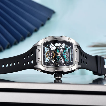 Luxury watch with black strap and silver case on a reflective surface