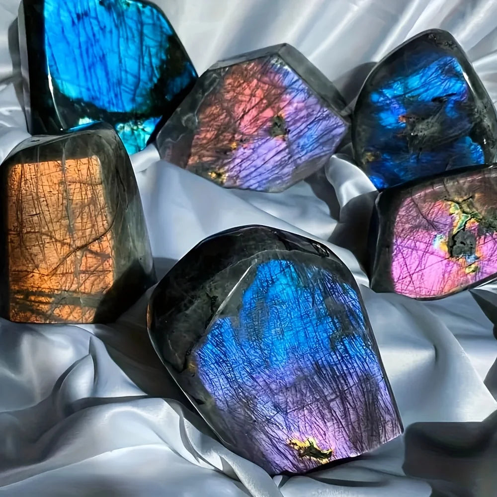 Multicolored labradorite stones on a white fabric background
