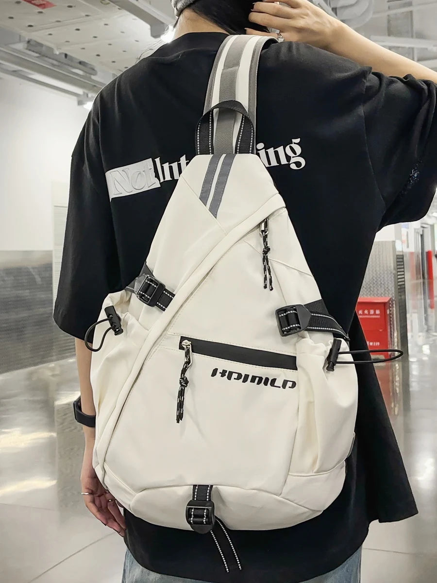 Person wearing a white backpack with black straps in an indoor setting