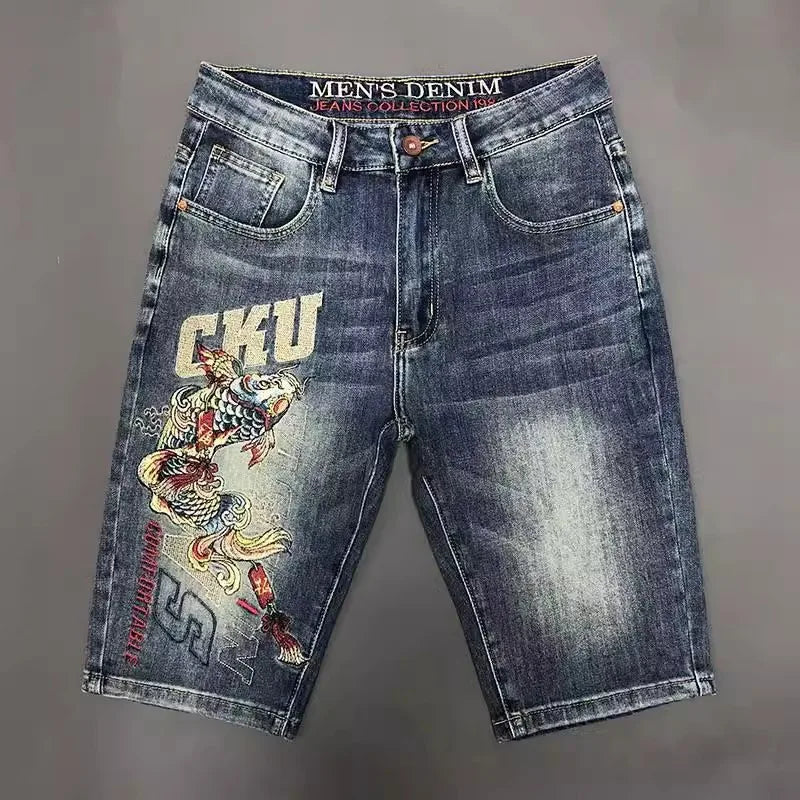 Denim shorts with a fish design and 'GKU' branding on a gray background