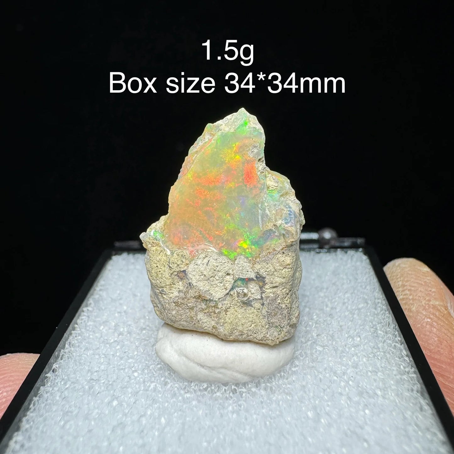 Opal stone on a display stand with size and weight information.