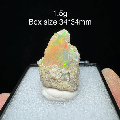 Opal stone on a display stand with size and weight information.