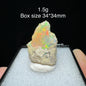 Opal stone on a display stand with size and weight information.