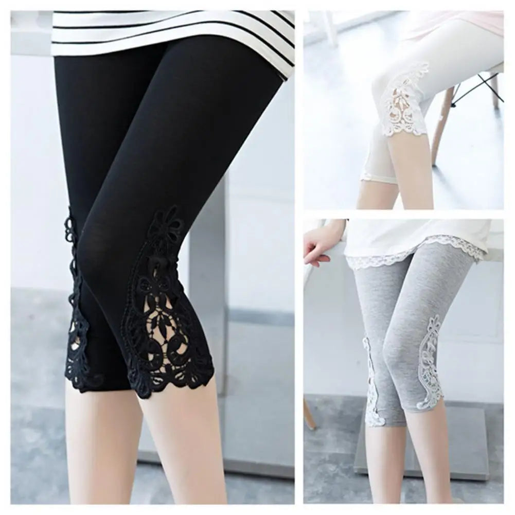Black and gray leggings with lace details on a neutral background