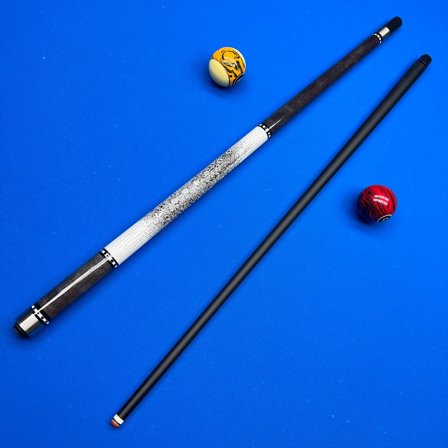Two pool cues on a blue background with two pool balls.