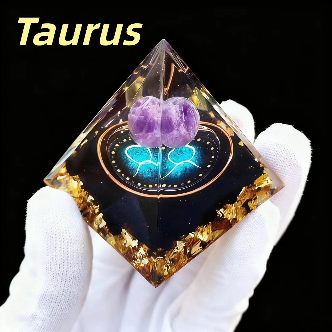 Pyramid-shaped crystal with purple stones and glowing blue design, held by a gloved hand with 'Taurus' text above.