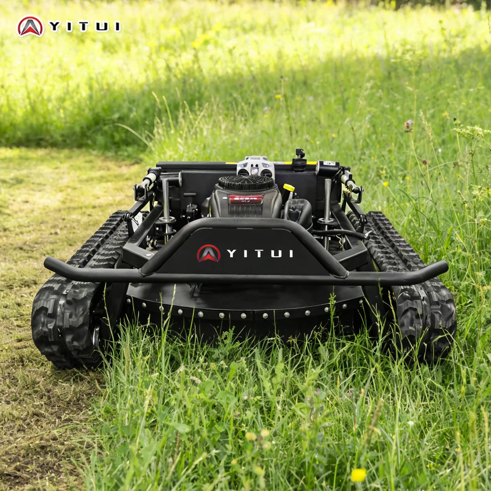 Robotic lawn mower on a grassy field with YITUI branding.
