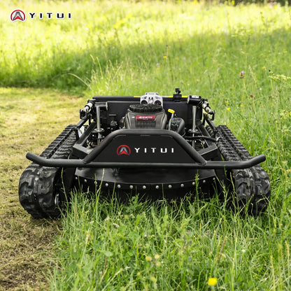 Robotic lawn mower on a grassy field with YITUI branding.