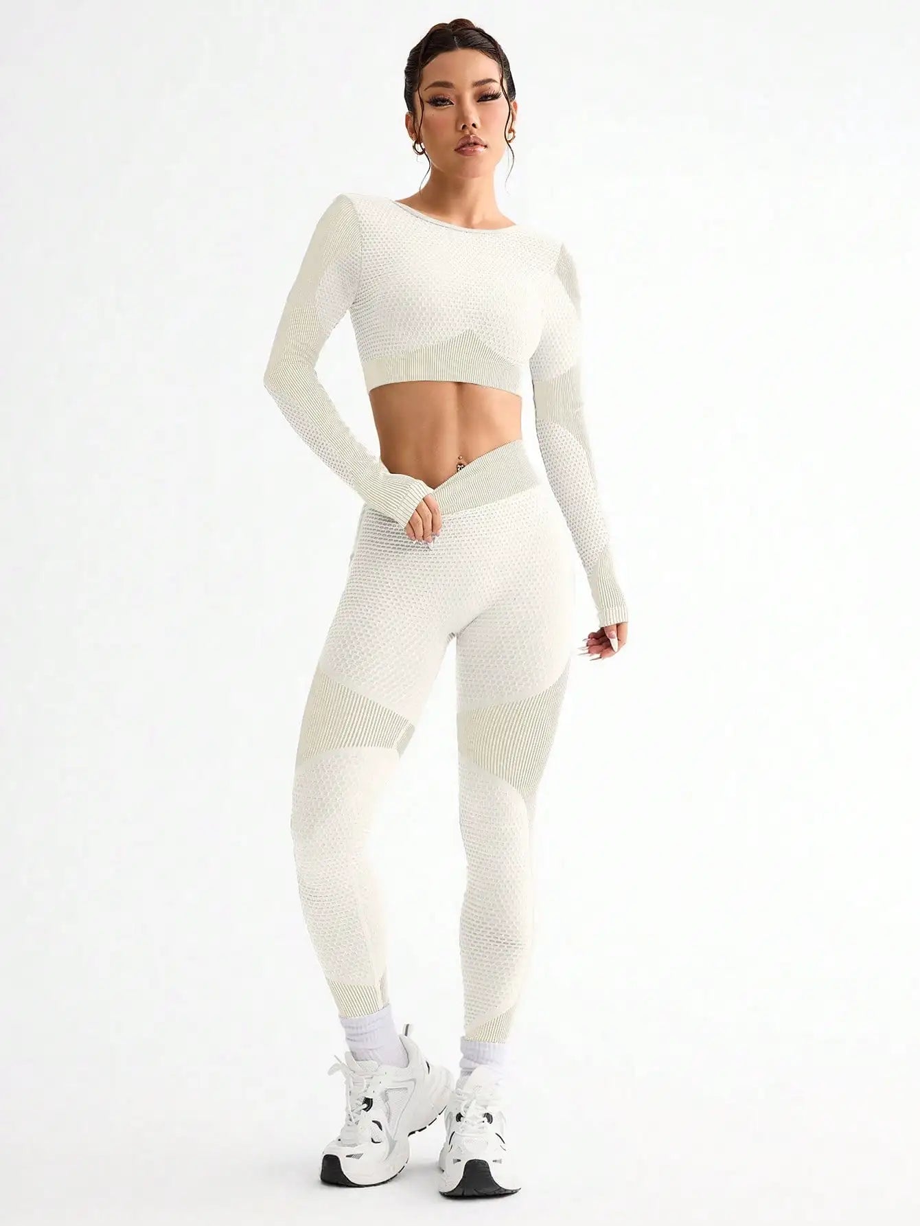 Woman wearing a white athletic outfit on a white background