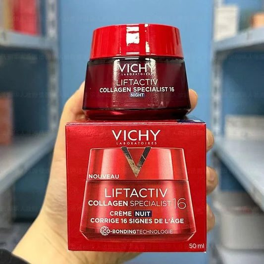 Vichy Liftactiv Collagen Specialist 16 night cream jar and box held in a hand with shelves in the background.