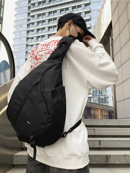 Person wearing a black backpack in an urban setting