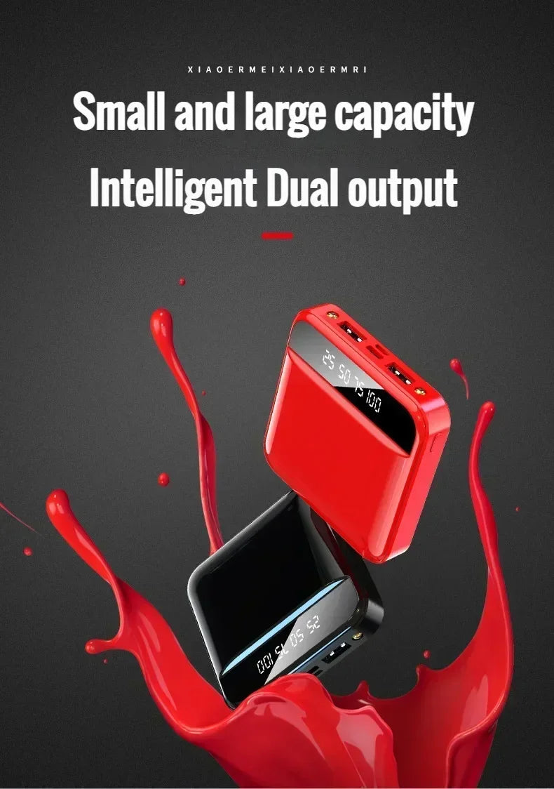 Red power bank with digital display on a black background with red splashes, text 'Small and large capacity Intelligent Dual output'.