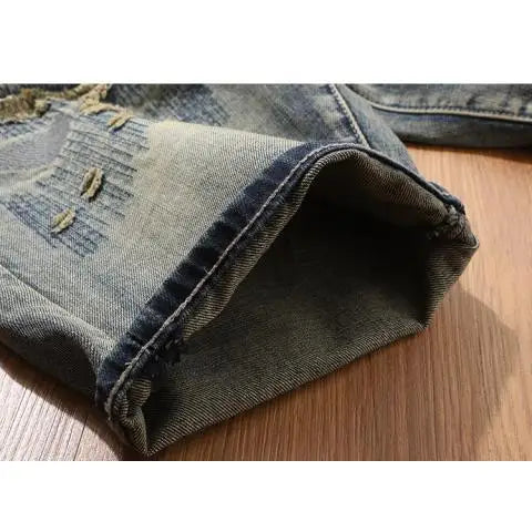 Close-up of a folded pair of jeans on a wooden surface