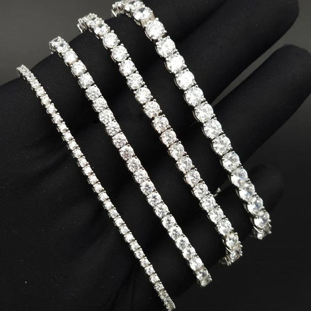 Three diamond tennis bracelets on a black background