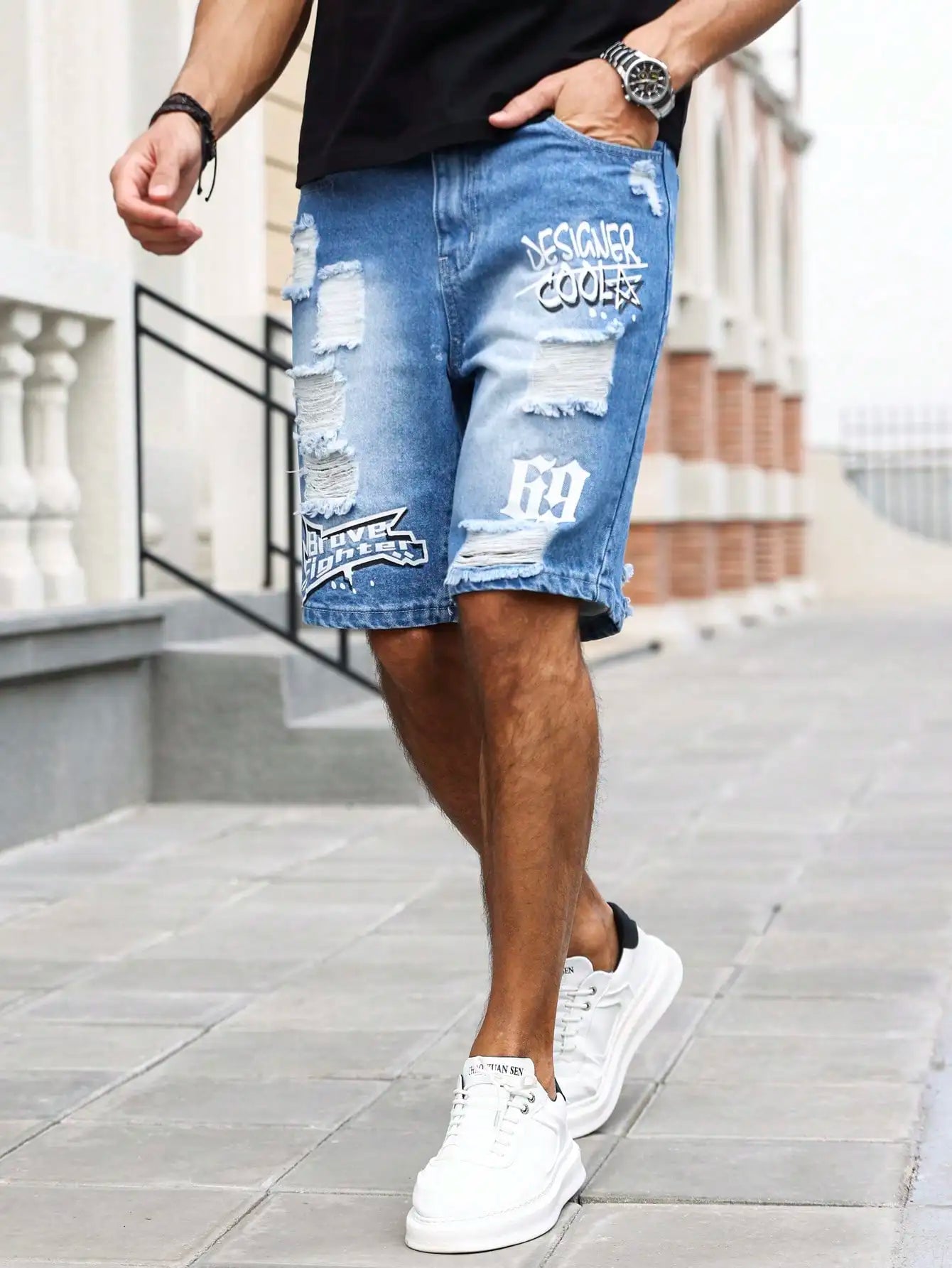 Person wearing ripped blue denim shorts with branding on a city street.
