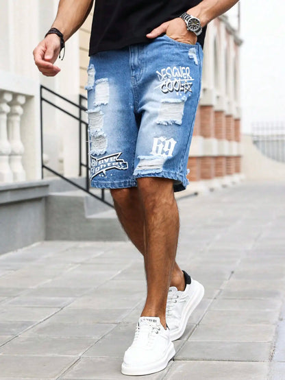 Person wearing ripped blue denim shorts with branding on a city street.