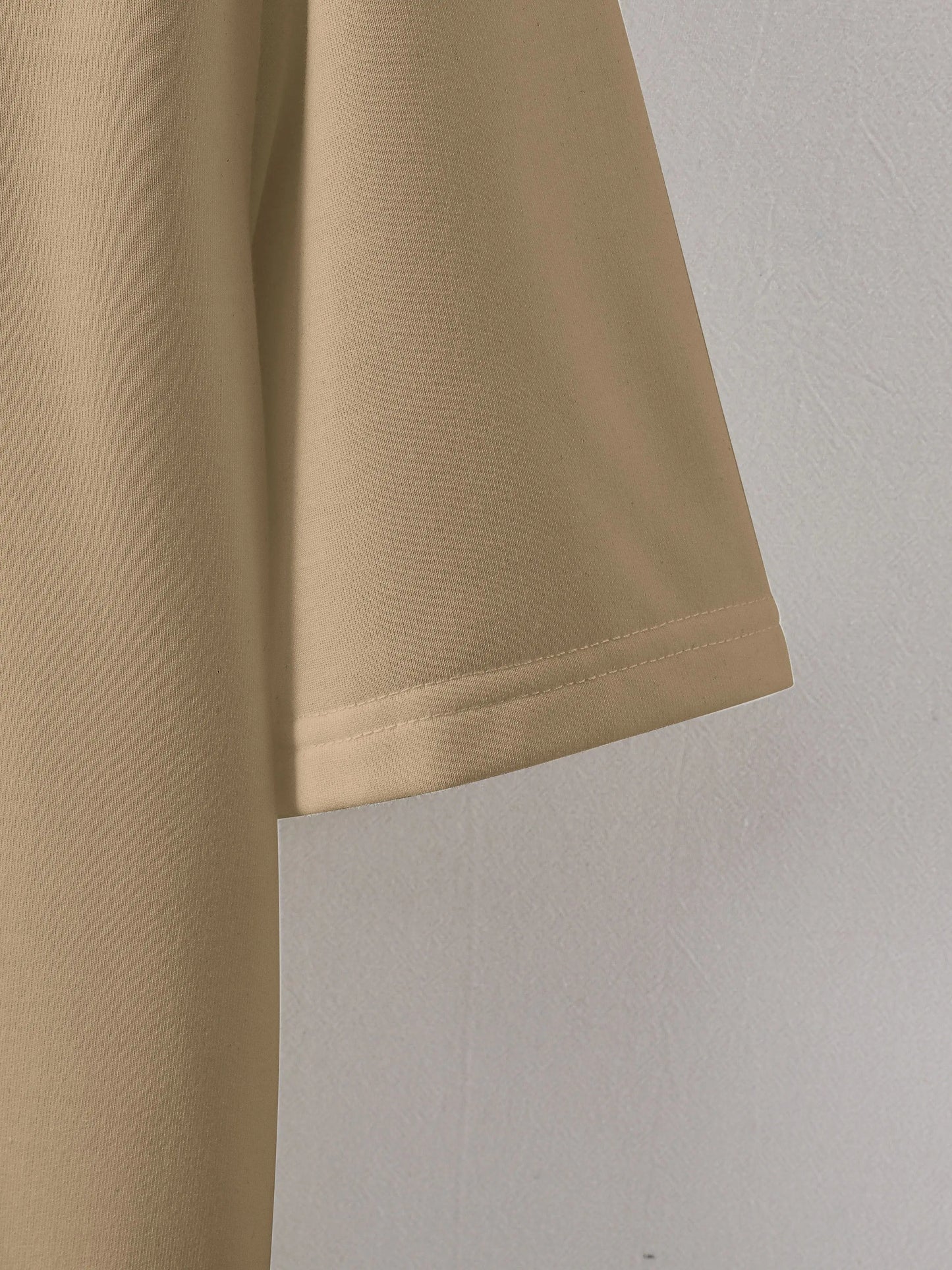 Close-up of beige shorts on a light gray background