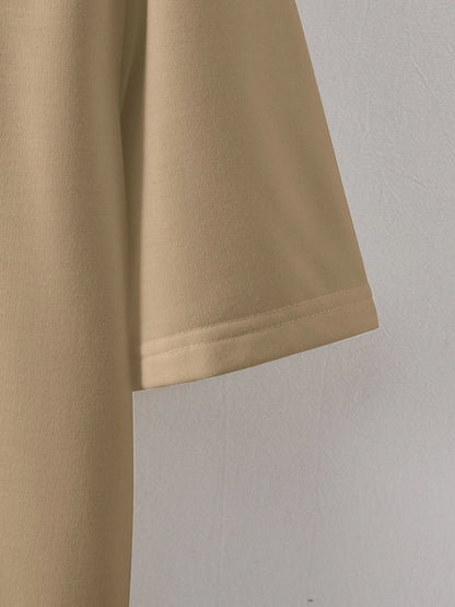 Close-up of beige shorts on a light gray background