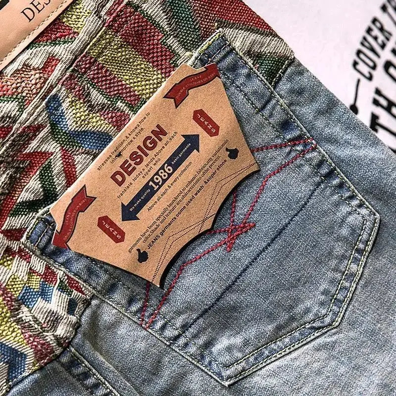 Close-up of a denim pocket with a brand label on a multicolored fabric background