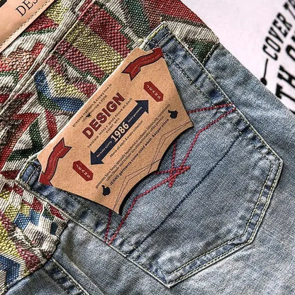 Close-up of a denim pocket with a brand label on a multicolored fabric background