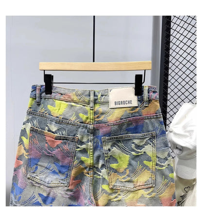 Colorful patterned denim shorts on a hanger with a visible brand label.