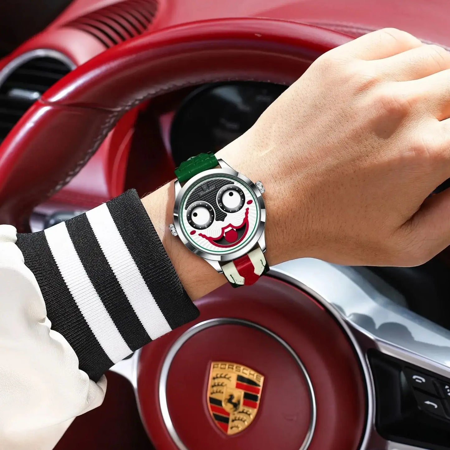 Hand wearing a unique watch with a car's steering wheel in the background