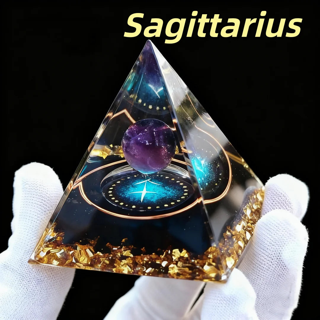 Triangular crystal pyramid with a purple sphere inside, held by white-gloved hands against a black background, with 'Sagittarius' text above.