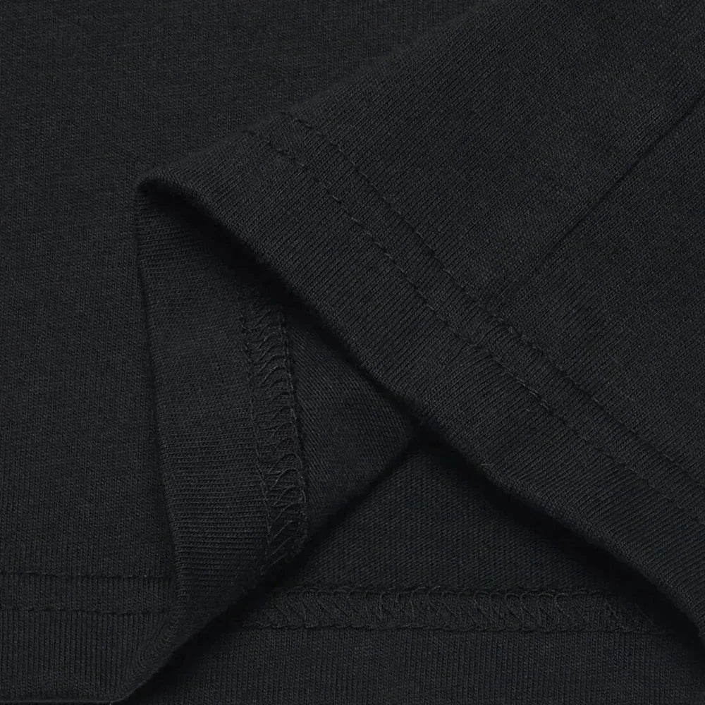 Close-up of black fabric with a visible brand logo.