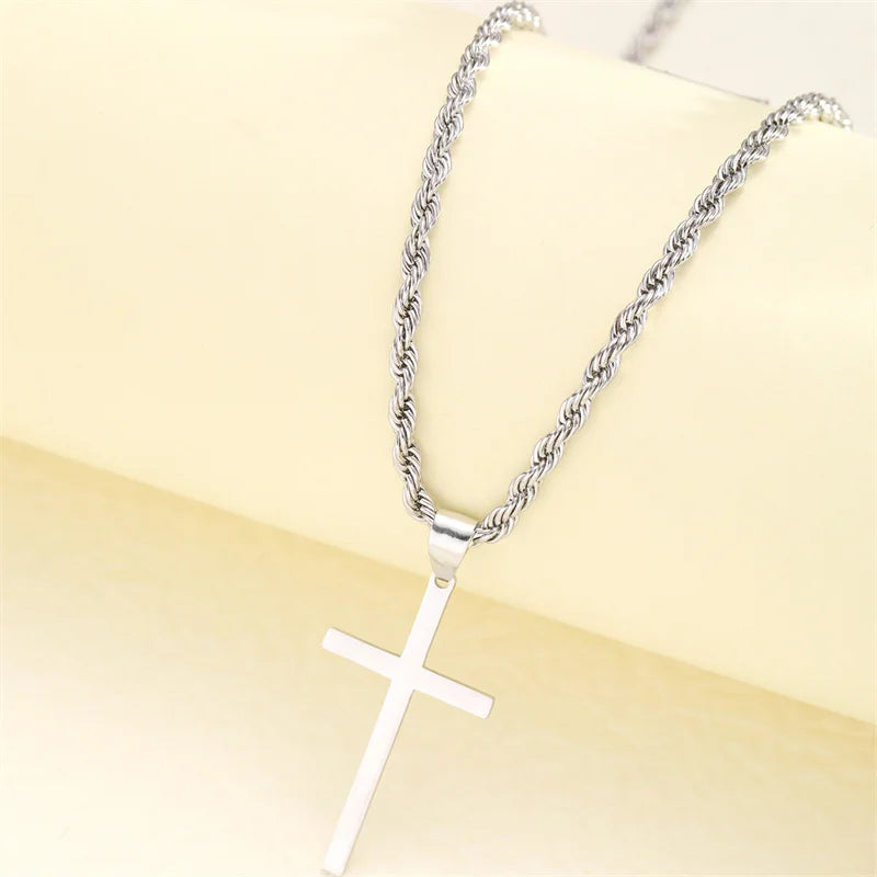 Silver cross necklace on a beige background