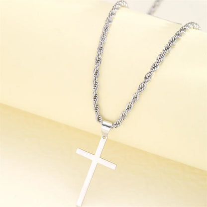 Silver cross necklace on a beige background