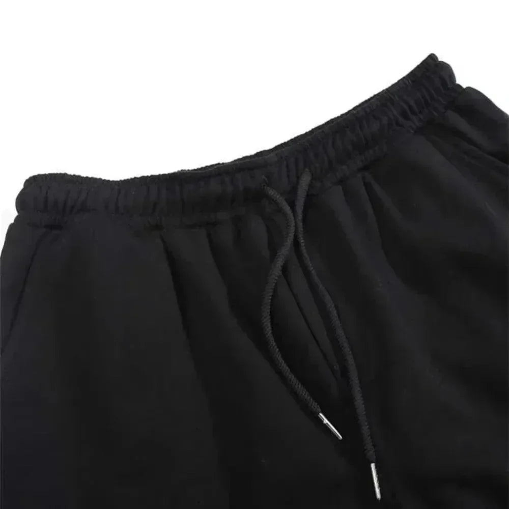 Close-up of black pants with drawstring on a white background