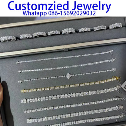 Collection of silver jewelry on a display card with contact information.