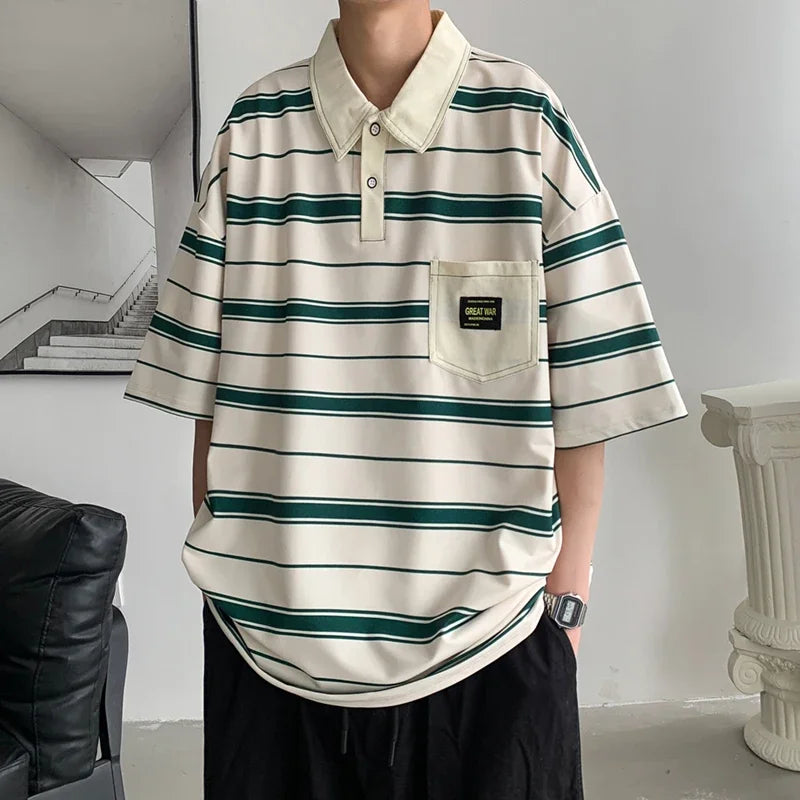 Person wearing a striped polo shirt with a pocket in an indoor setting