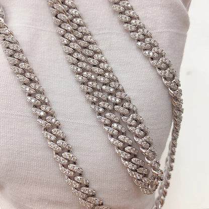 Silver chain necklace on a white fabric background