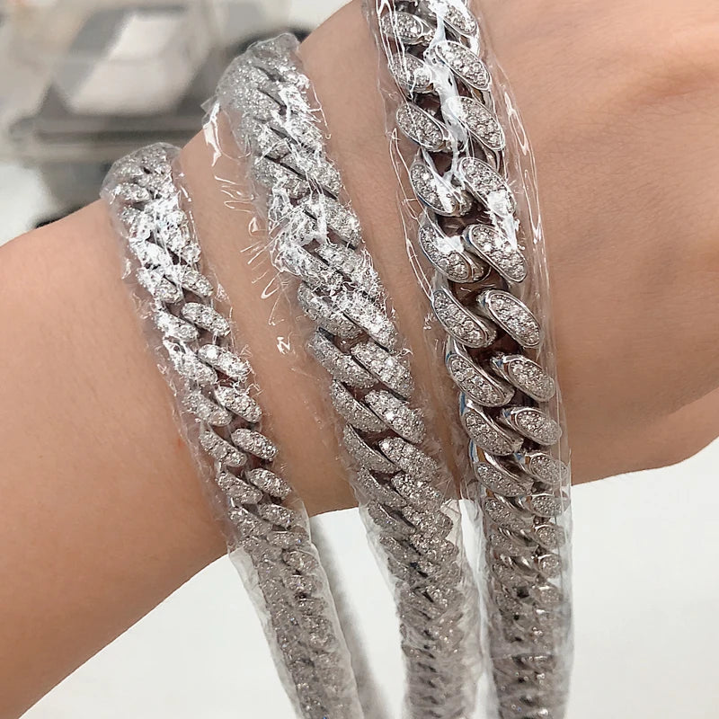 Silver chain bracelets on a wrist with a blurred background