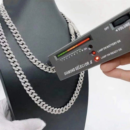 Diamond selector being used on a silver chain against a black background