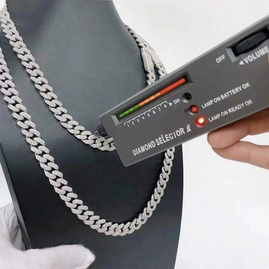 Diamond selector being used on a silver chain against a black background