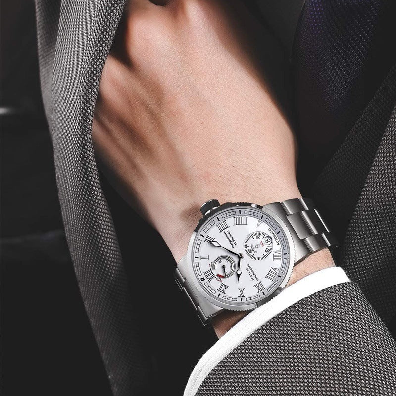 Silver wristwatch on a person's wrist with a dark suit background