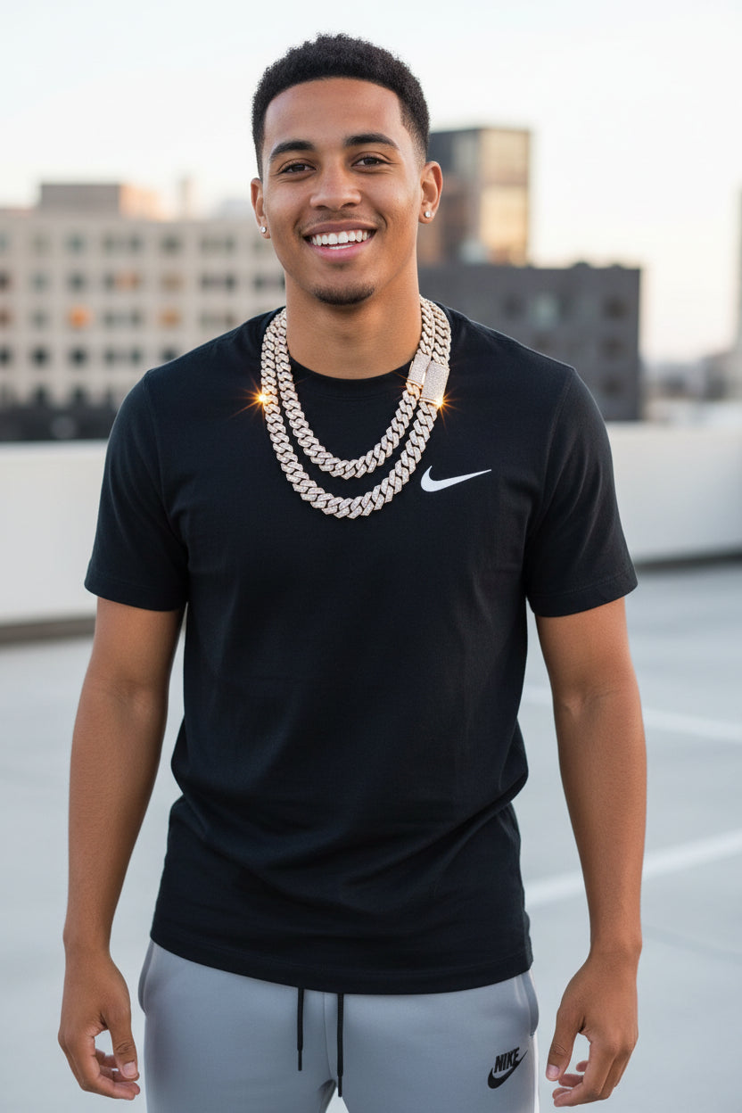 Man wearing a black Nike t-shirt and gray pants on a rooftop with a cityscape background