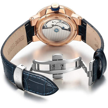 Luxury watch with rose gold case and blue leather strap on a white background
